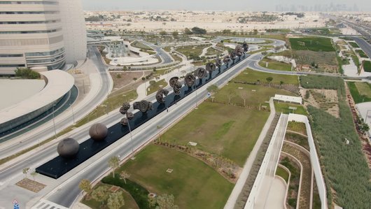 Aerial view of the fourteen bronze sculptures of The Miraculous Journey along the entrance to Sidra Medicine.